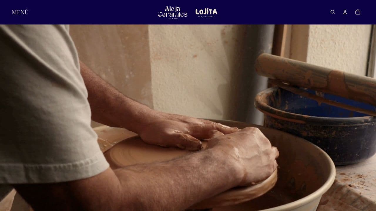 Aloja Ceramics homepage showing an artisan shaping clay by hand